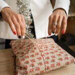 Woman with cool nail polish wrapping a last minute holiday gift